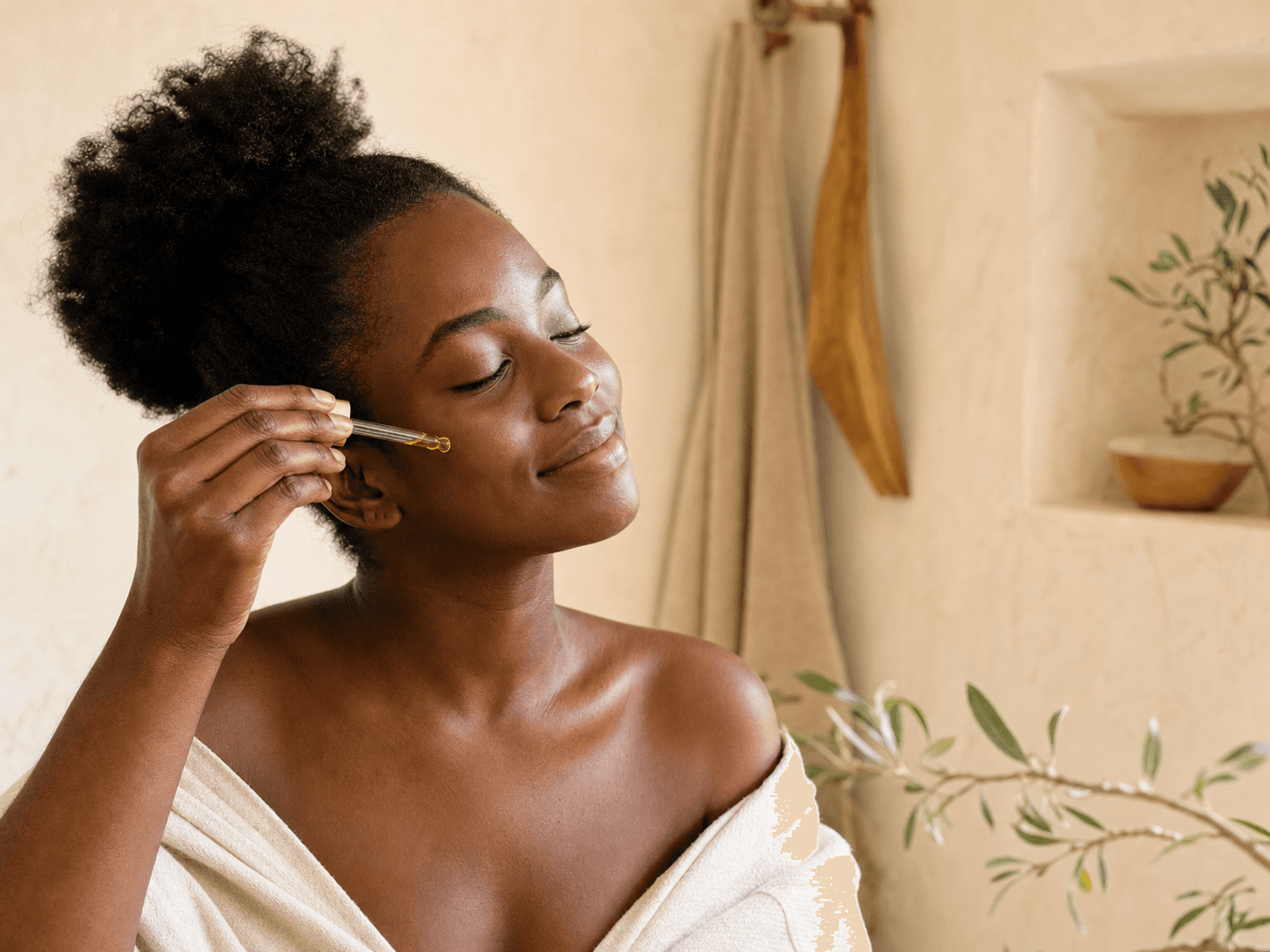 A woman enjoying a calming facial oil ritual